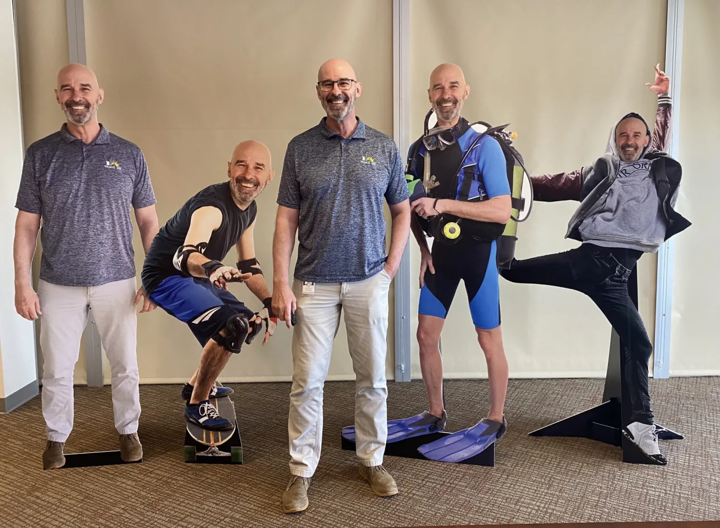 District employees posing with superintendent cutouts for the Workvivo launch challenge